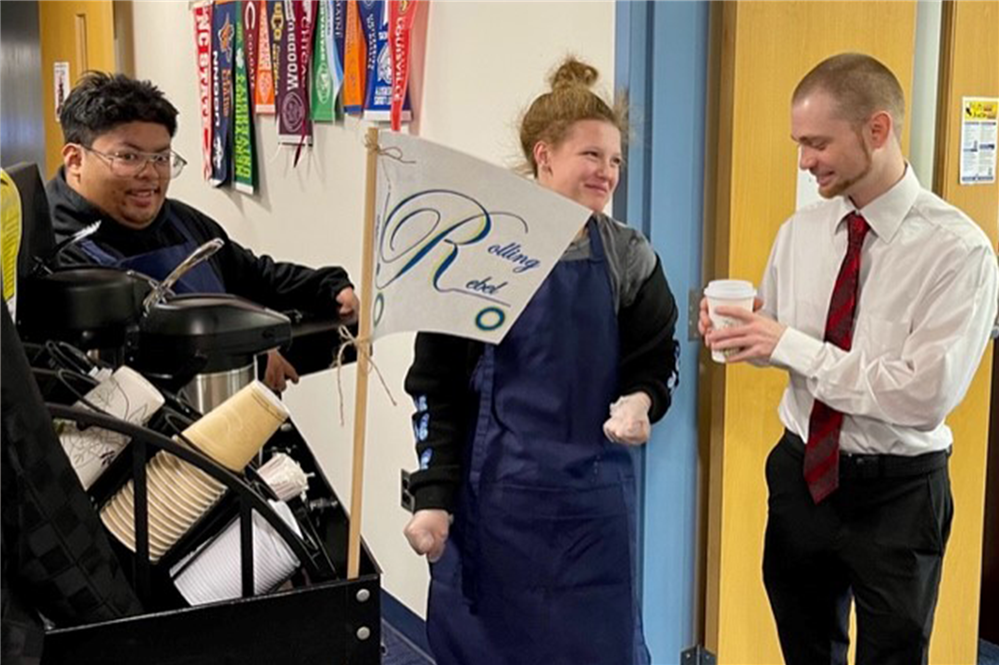  APW Students share coffee with a teacher.